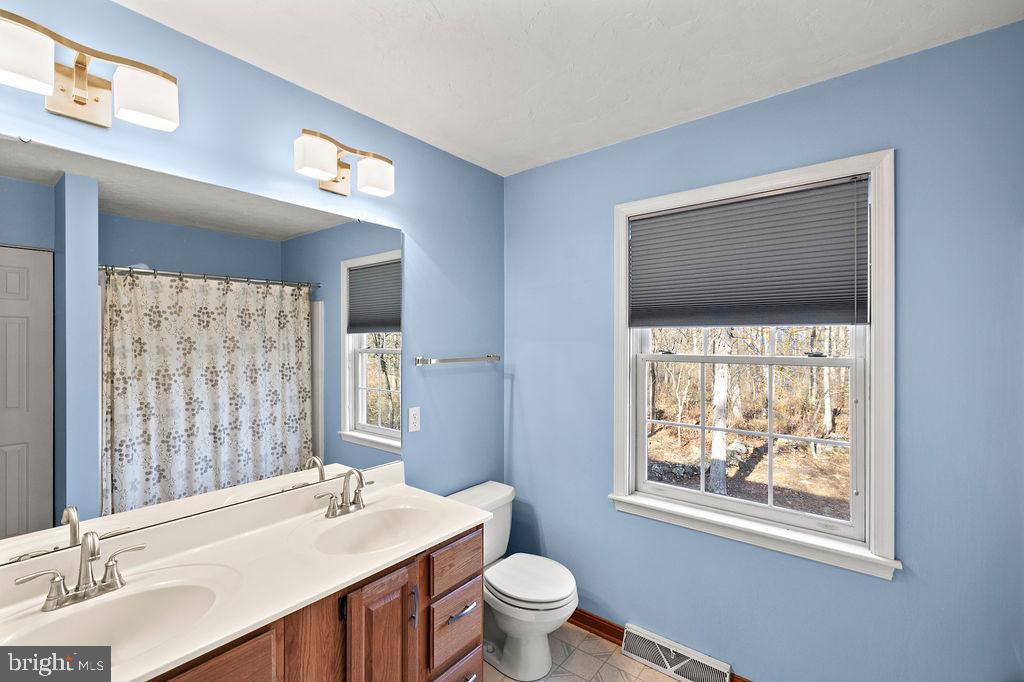 105 Round Top Lane Gettysburg, PA 17325 - Photo 34 of 50 a bathroom with a sink a toilet and mirror