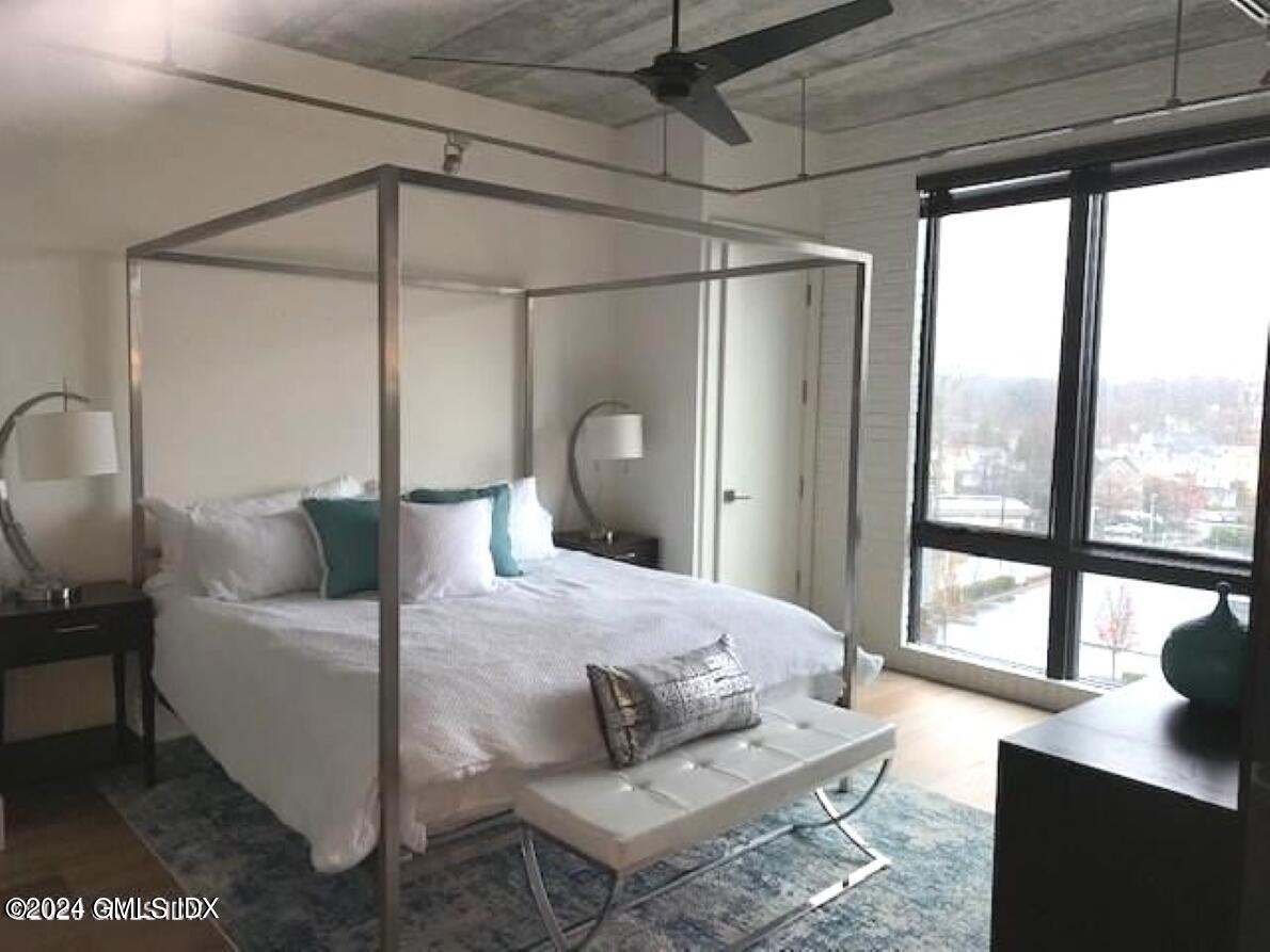 16 Old Track Road, Unit PH #3 Greenwich, CT 06830 - Photo 12 of 25 a bedroom with a bed window and a table