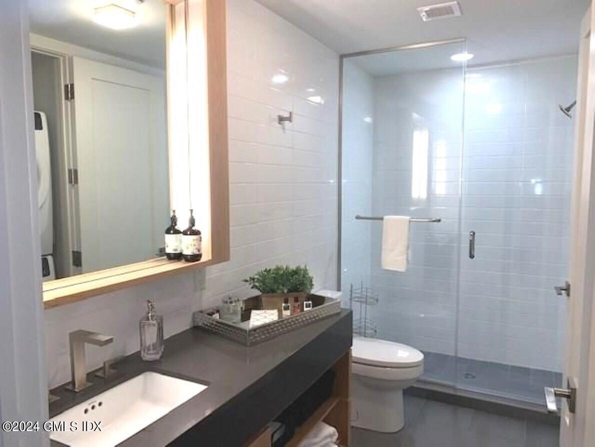 16 Old Track Road, Unit PH #3 Greenwich, CT 06830 - Photo 14 of 25 a bathroom with a sink a toilet and shower