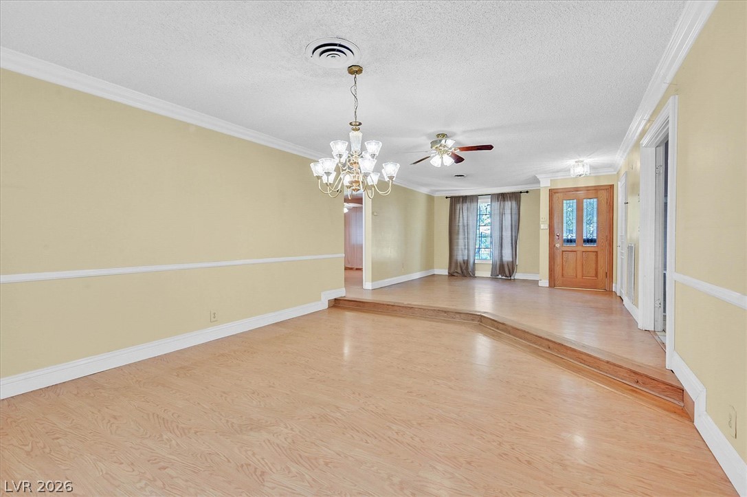 3618 Fieldcrest Road Las Vegas, NV 89121 - Photo 2 of 36 A split-level layout with polished wood flooring creates distinct living spaces.