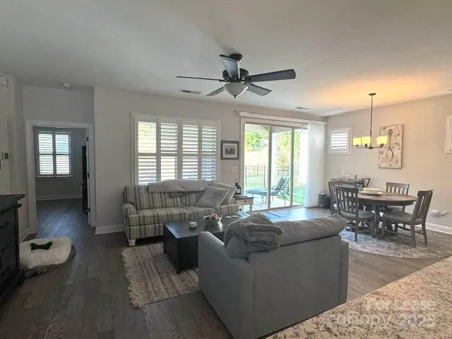 a living room with furniture dining table and a large window