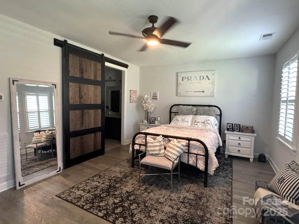 4995 Looking Glass Trail Denver, NC 28037 - Photo 14 of 32 a bedroom with a bed and a chandelier