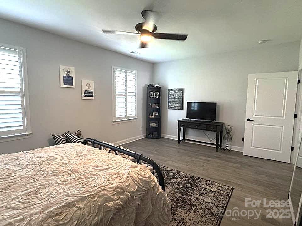 4995 Looking Glass Trail Denver, NC 28037 - Photo 15 of 32 a bedroom with a bed and a chandelier