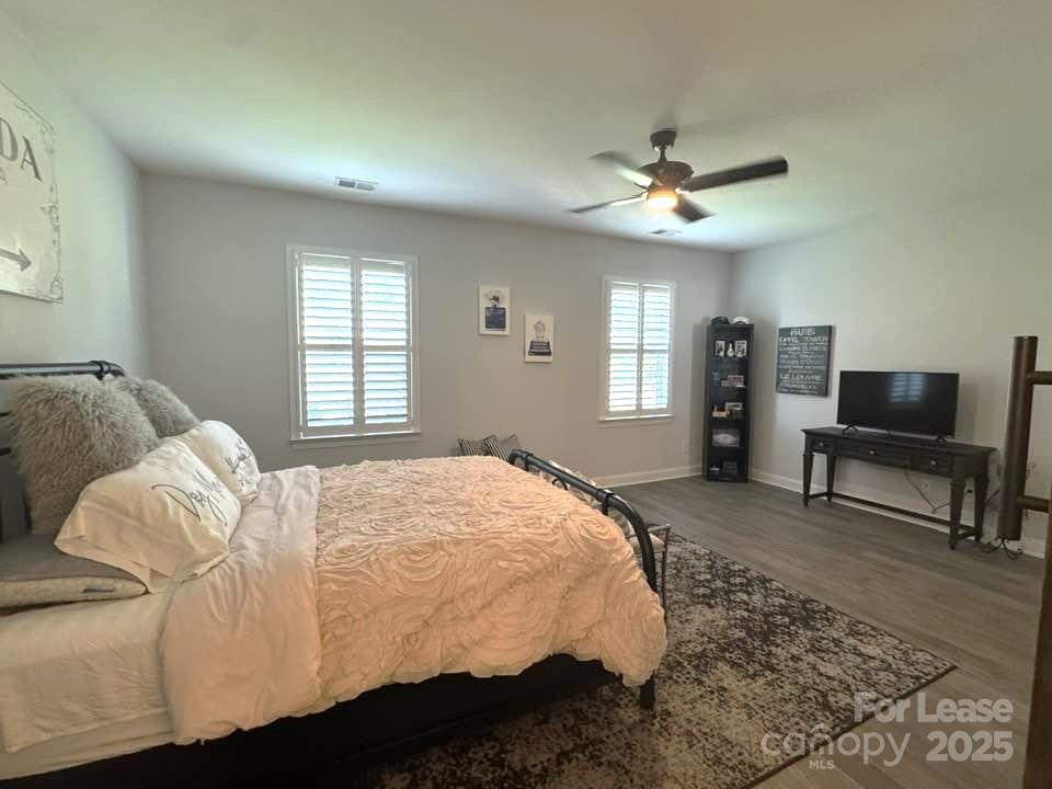 4995 Looking Glass Trail Denver, NC 28037 - Photo 17 of 32 a spacious bedroom with a bed and a chandelier