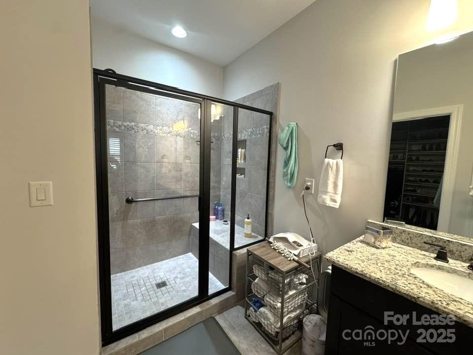4995 Looking Glass Trail Denver, NC 28037 - Photo 21 of 32 a bathroom with a granite countertop sink a mirror and shower