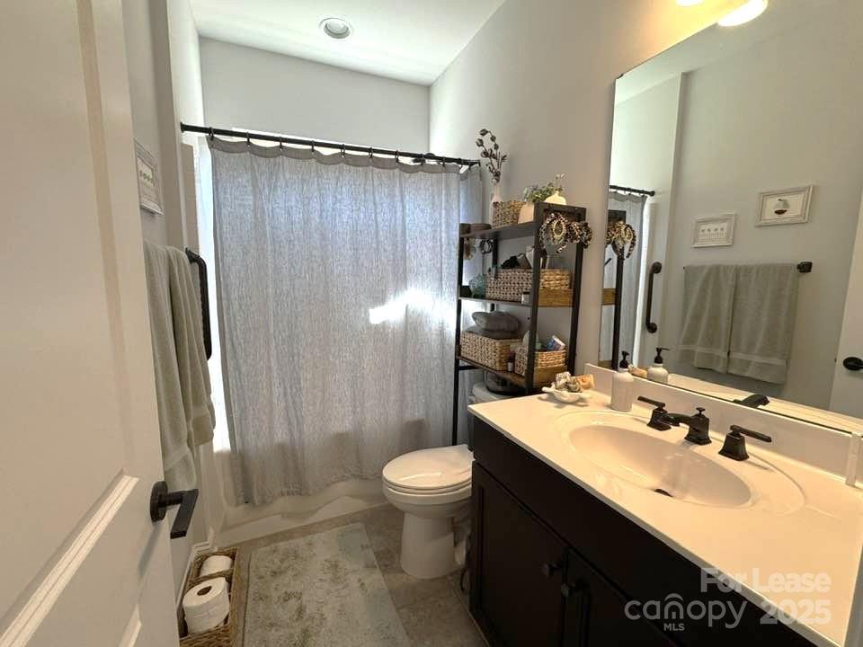 4995 Looking Glass Trail Denver, NC 28037 - Photo 25 of 32 a bathroom with a double vanity sink toilet mirror and shower