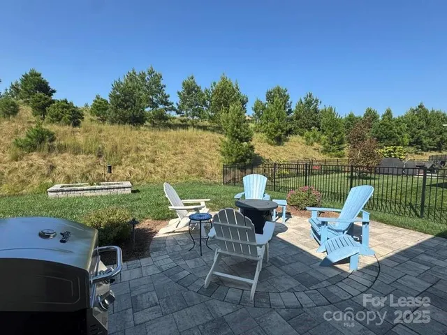 a view of a garden with plants and outdoor seating