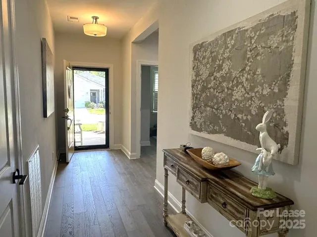 a view of a room with wooden floor and a window
