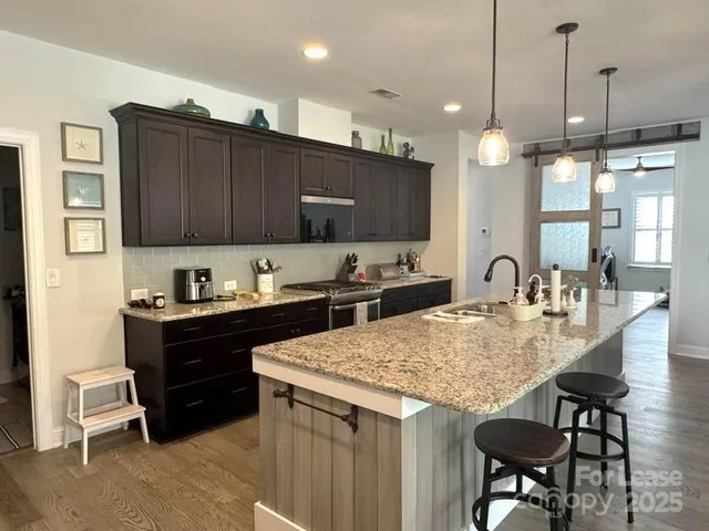 a kitchen with refrigerator and chairs