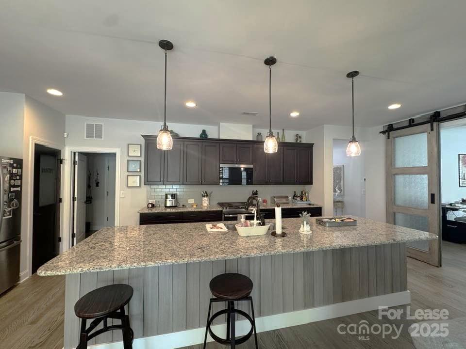 4995 Looking Glass Trail Denver, NC 28037 - Photo 8 of 32 a kitchen with refrigerator and chairs