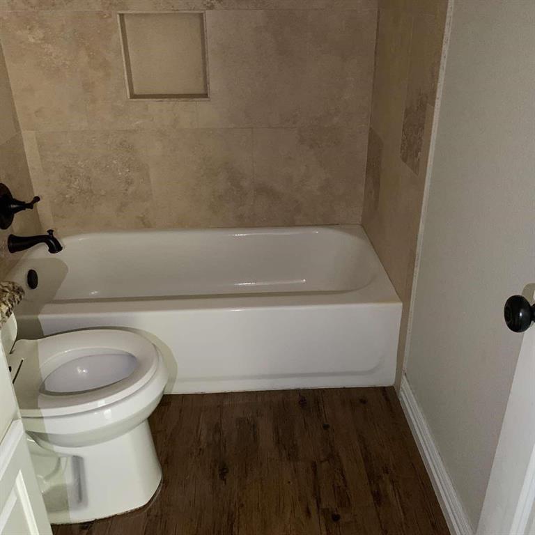 409 Maple Row Denison, TX 75021 - Photo 14 of 19 a bathroom with a sink and a toilet