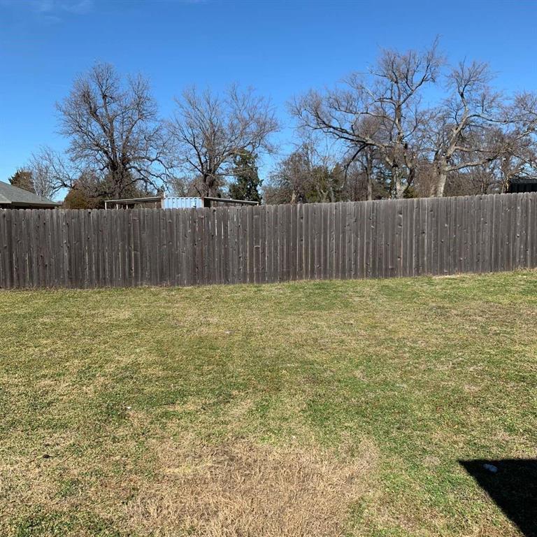 409 Maple Row Denison, TX 75021 - Photo 18 of 19 a view of backyard with tree