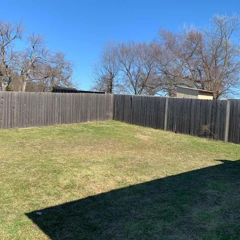 a swimming pool with wooden fence
