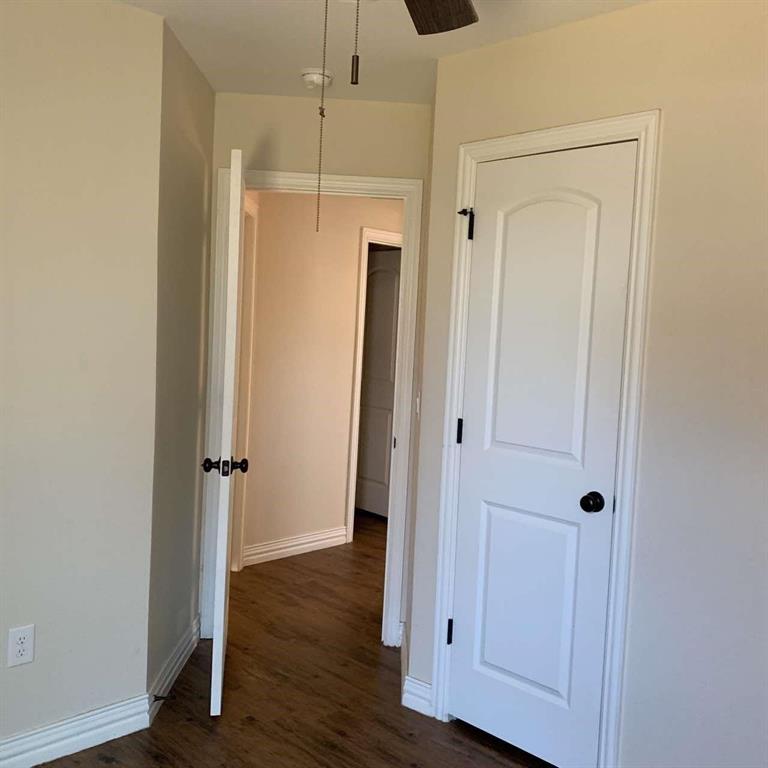409 Maple Row Denison, TX 75021 - Photo 7 of 19 a view of a hallway with wooden floor