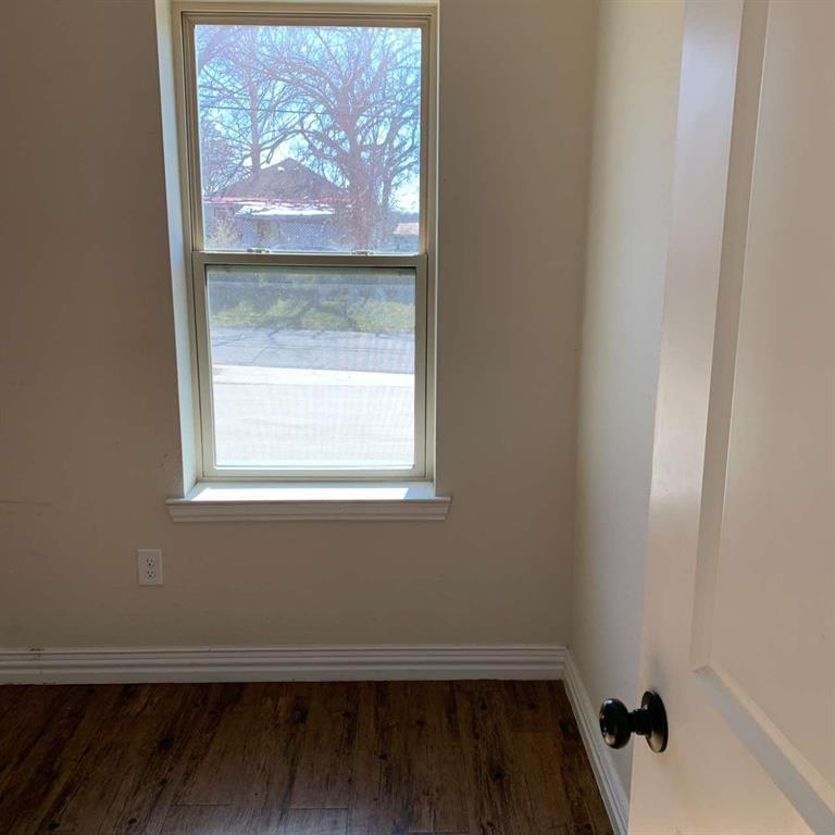 409 Maple Row Denison, TX 75021 - Photo 9 of 19 a view of a small space with wooden floor and a window