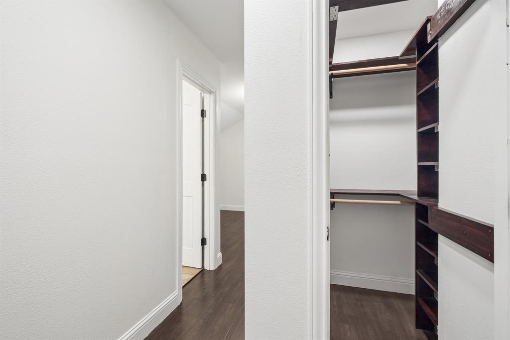 15539 Preston Road, Unit 1037 Dallas, TX 75248 - Photo 31 of 36 Custom closet system with wood-finish shelving and hanging rods