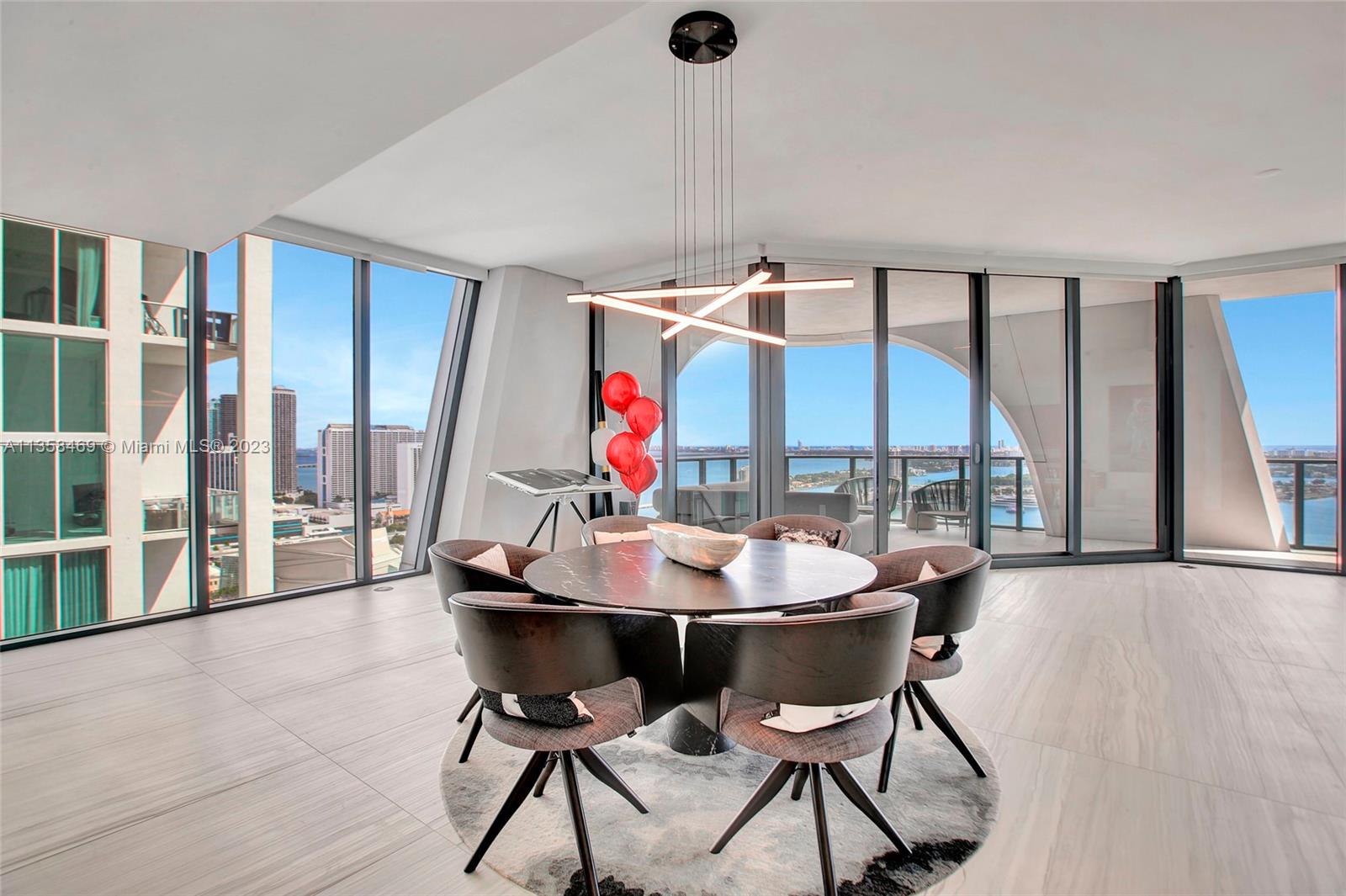 1000 Biscayne Boulevard, Unit 2802 Miami, FL 33132 - Photo 16 of 38 a view of a dining room with furniture large windows and wooden floor