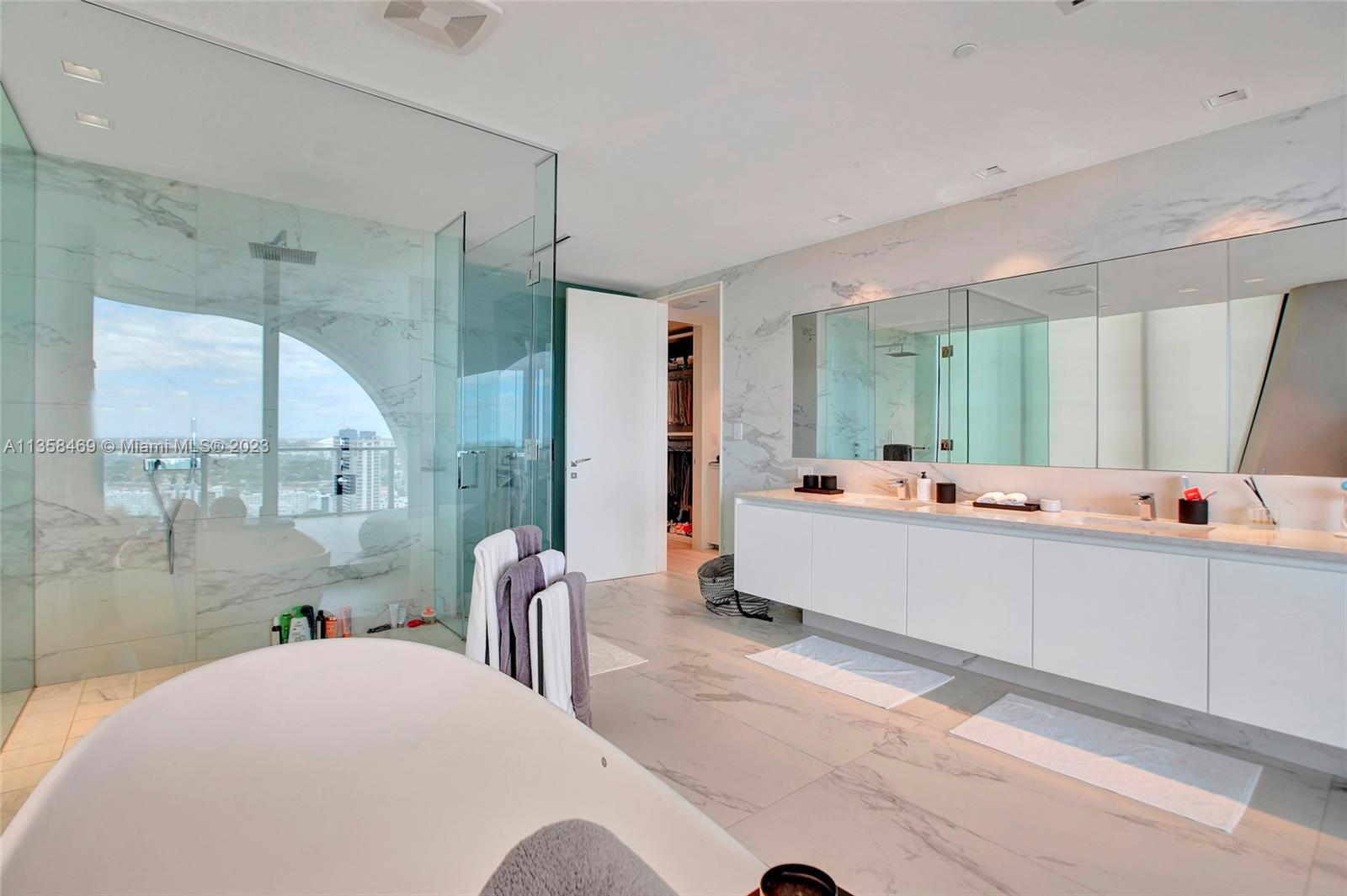 1000 Biscayne Boulevard, Unit 2802 Miami, FL 33132 - Photo 23 of 38 a bathroom with a double vanity sink mirror and shower