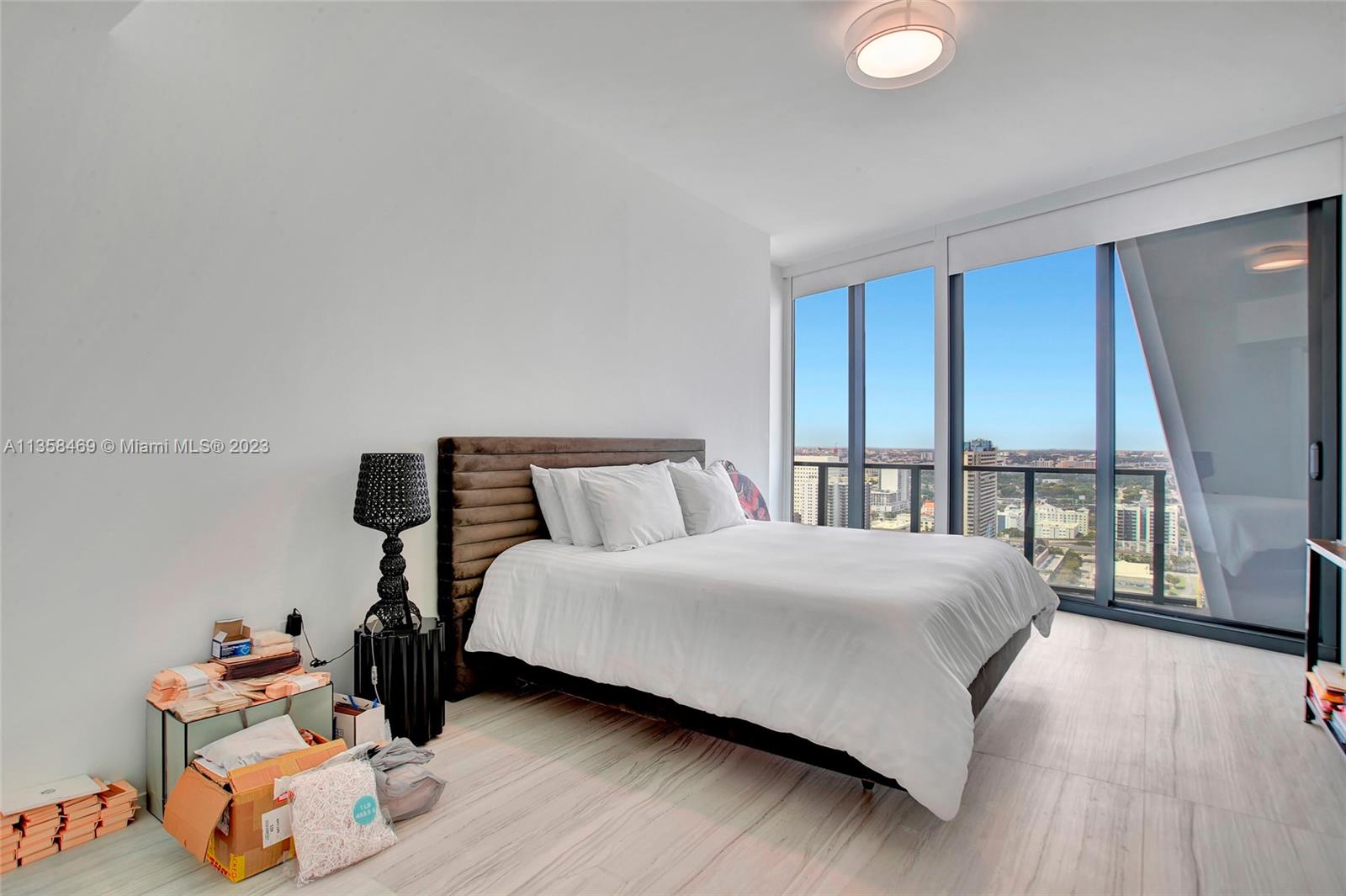 1000 Biscayne Boulevard, Unit 2802 Miami, FL 33132 - Photo 29 of 38 a bedroom with a bed and a large window