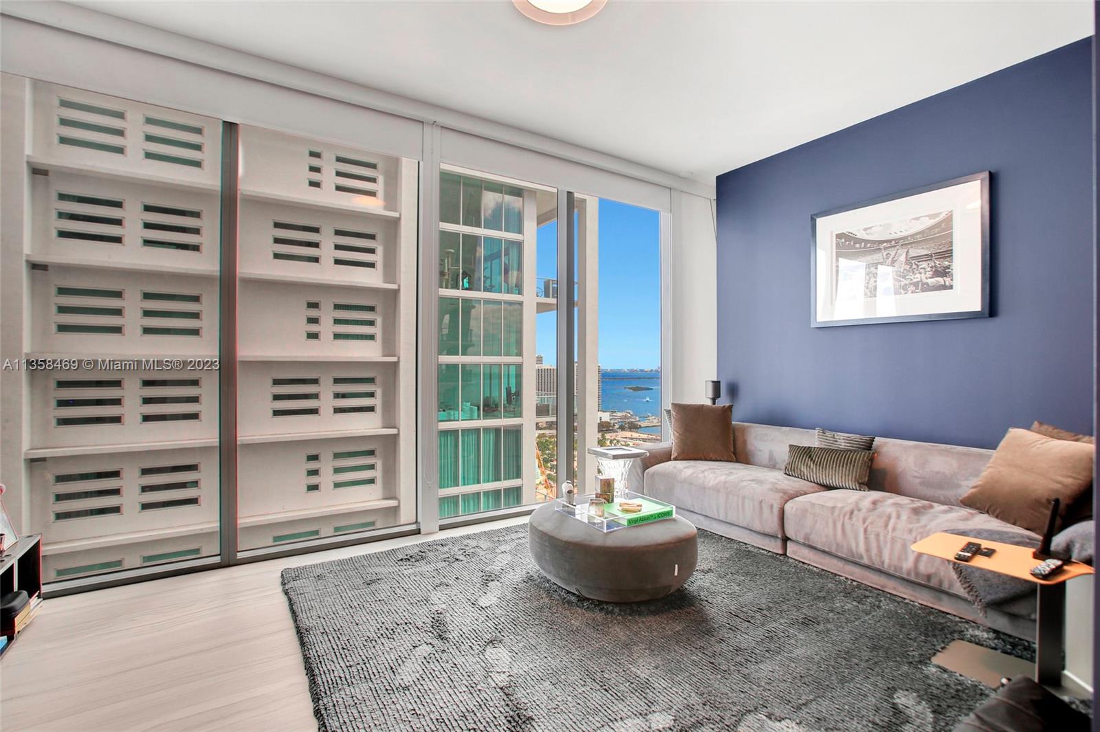 1000 Biscayne Boulevard, Unit 2802 Miami, FL 33132 - Photo 30 of 38 a living room with furniture and a window