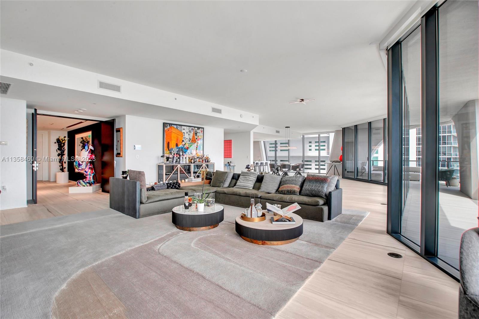 1000 Biscayne Boulevard, Unit 2802 Miami, FL 33132 - Photo 7 of 38 a living room with lots of white furniture and window