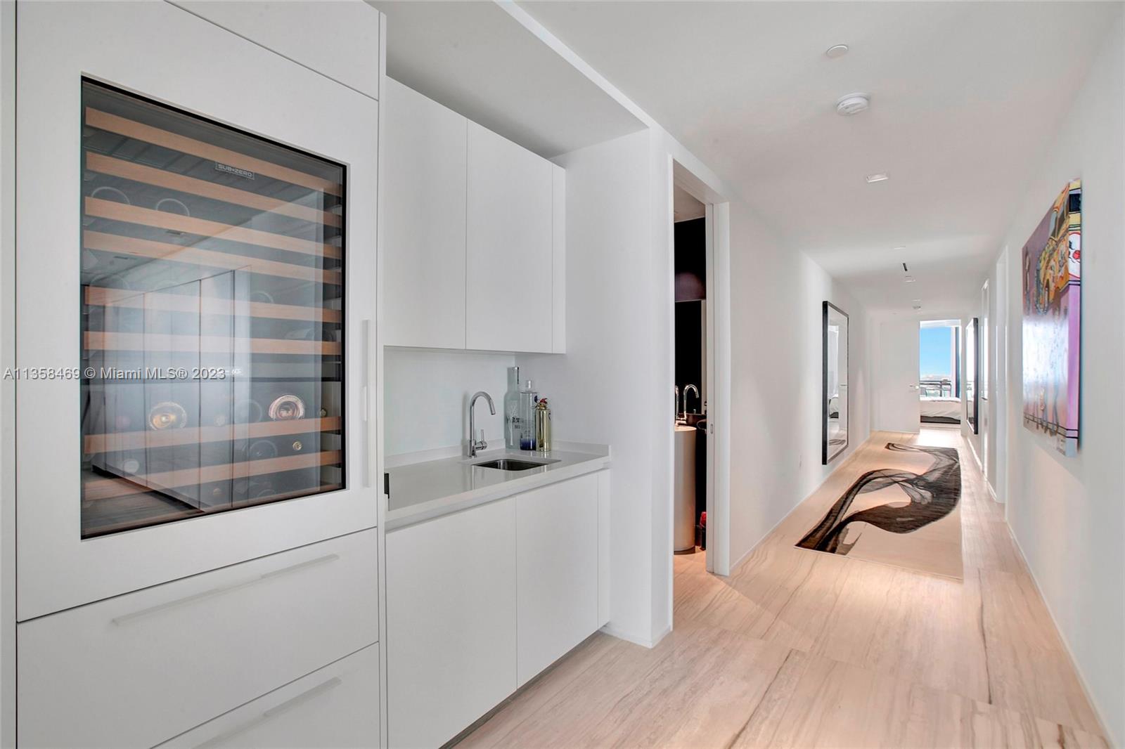 1000 Biscayne Boulevard, Unit 2802 Miami, FL 33132 - Photo 9 of 38 a view of a kitchen with a sink and a refrigerator