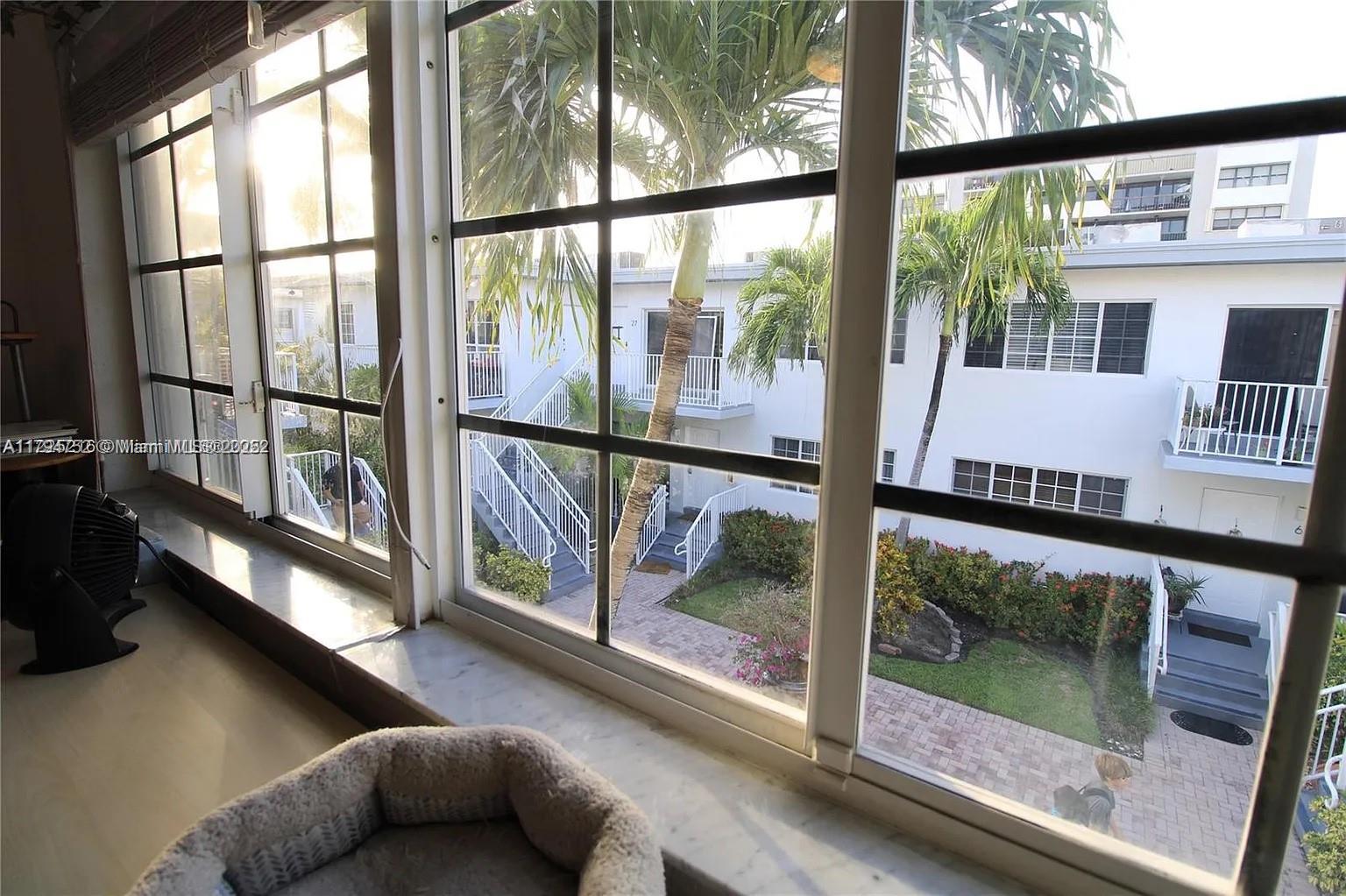 9260 Bay Harbor Terrace, Unit 22 Bay Harbor Islands, FL 33154 - Photo 11 of 24 a living room with a large window