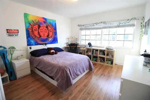 a bedroom with furniture and a window