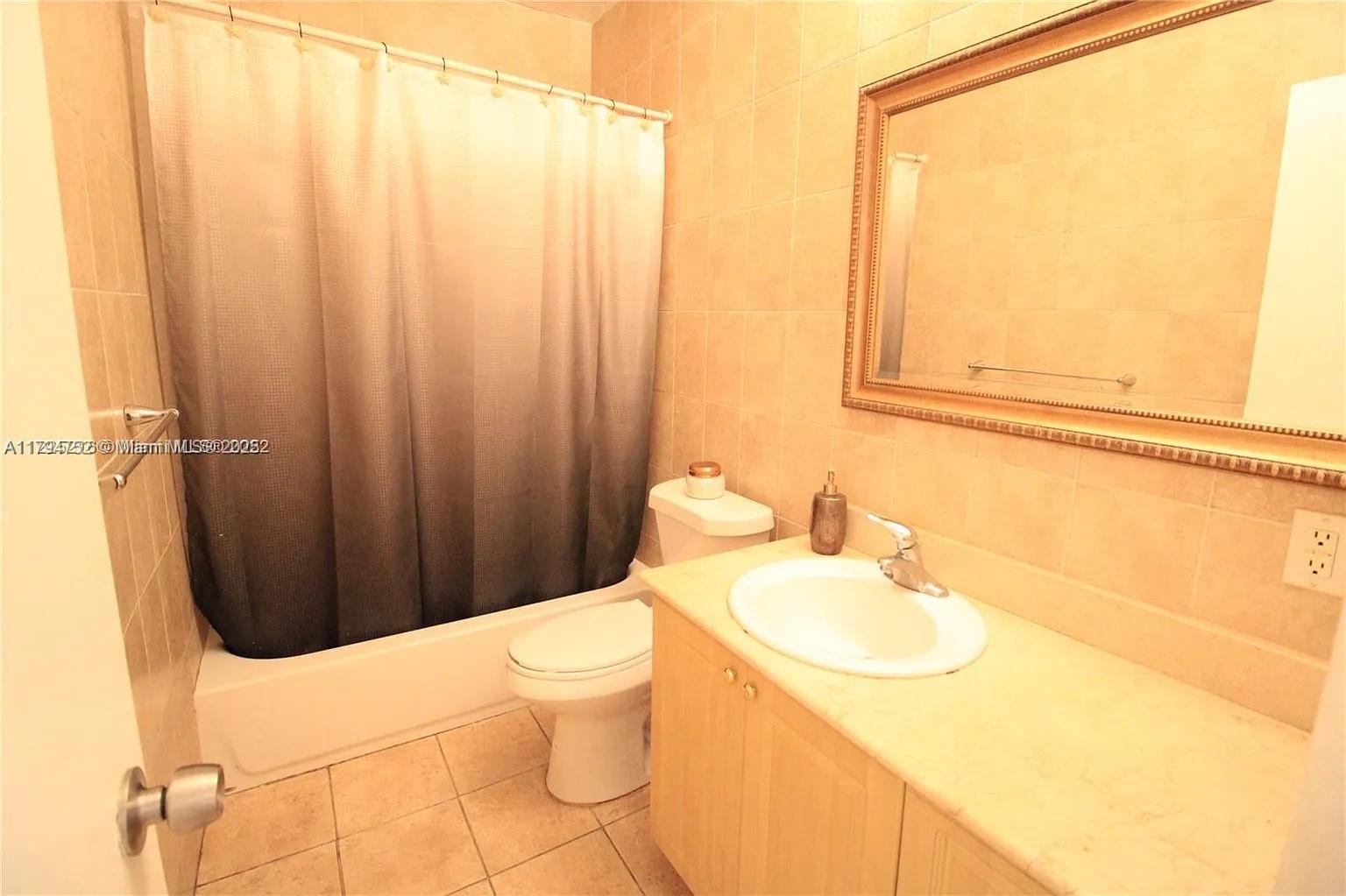 9260 Bay Harbor Terrace, Unit 22 Bay Harbor Islands, FL 33154 - Photo 13 of 24 a bathroom with a sink a toilet and shower