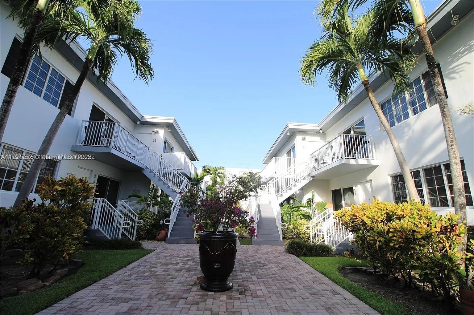 9260 Bay Harbor Terrace, Unit 22 Bay Harbor Islands, FL 33154 - Photo 19 of 24 a front view of a house with a garden