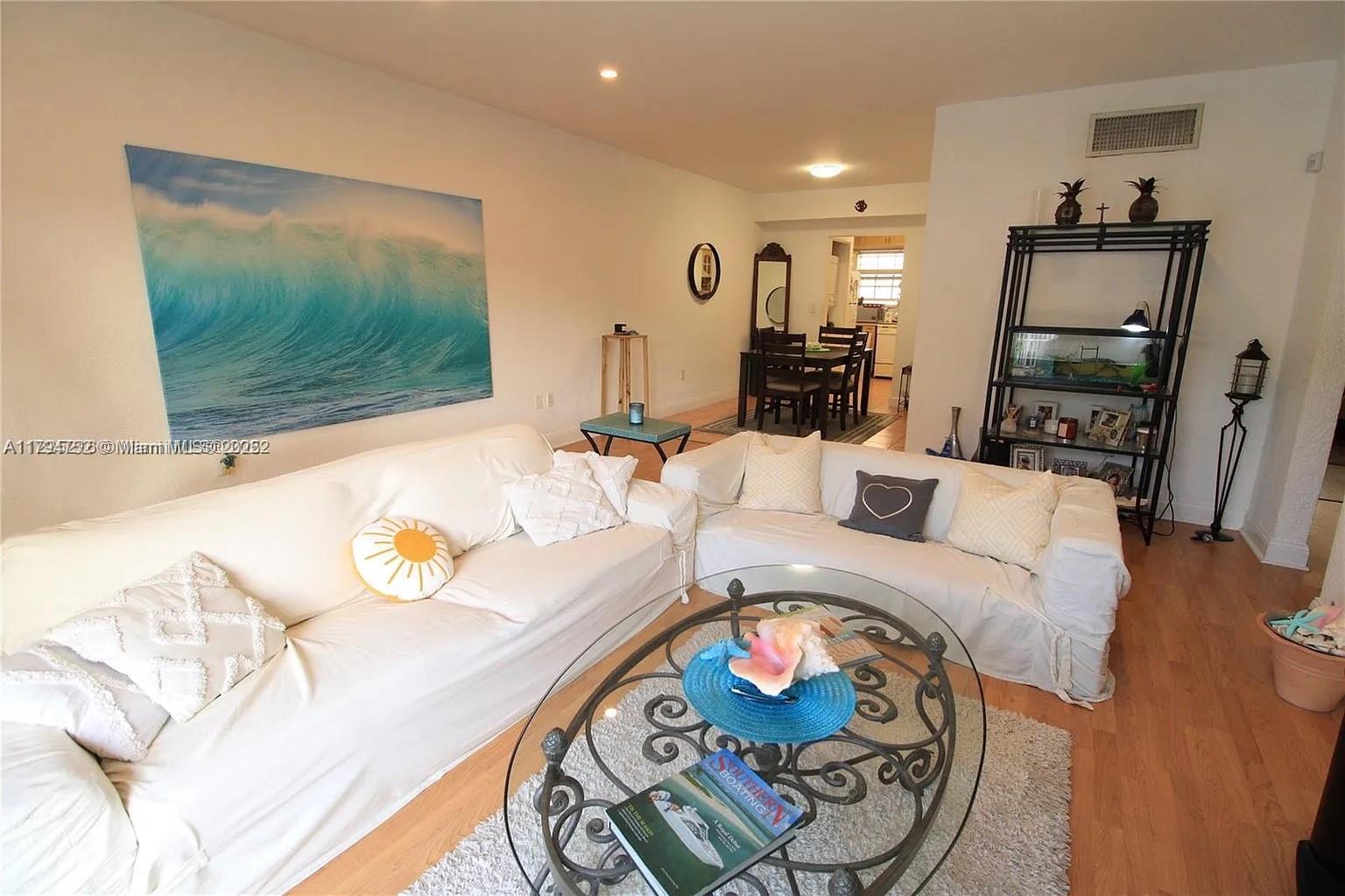 9260 Bay Harbor Terrace, Unit 22 Bay Harbor Islands, FL 33154 - Photo 3 of 24 a living room with furniture and a flat screen tv