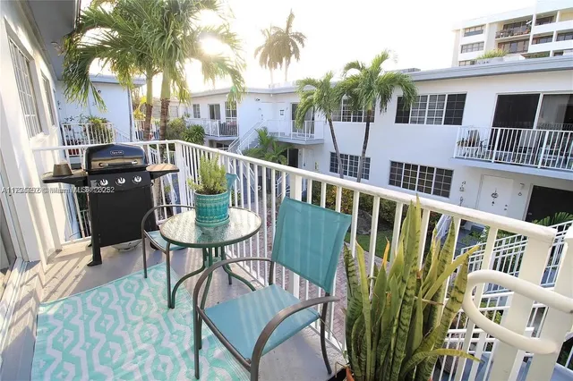 a view of a chair and table in the balcony