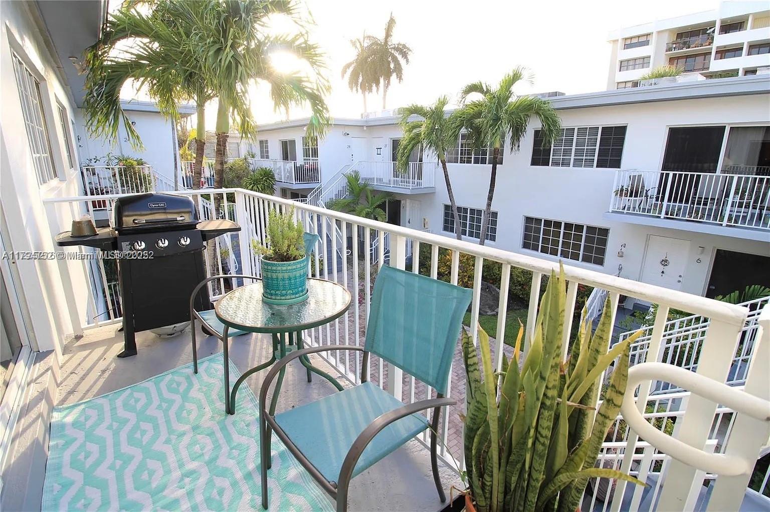 9260 Bay Harbor Terrace, Unit 22 Bay Harbor Islands, FL 33154 - Photo 8 of 24 a view of a chair and table in the balcony