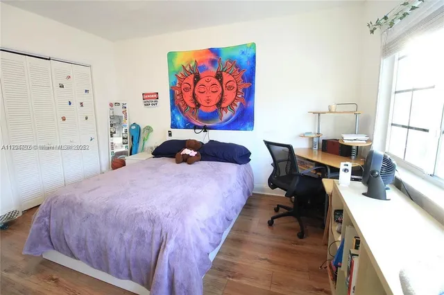 a bed room with a bed and a chair