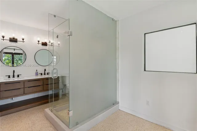 a bathroom with a glass shower door