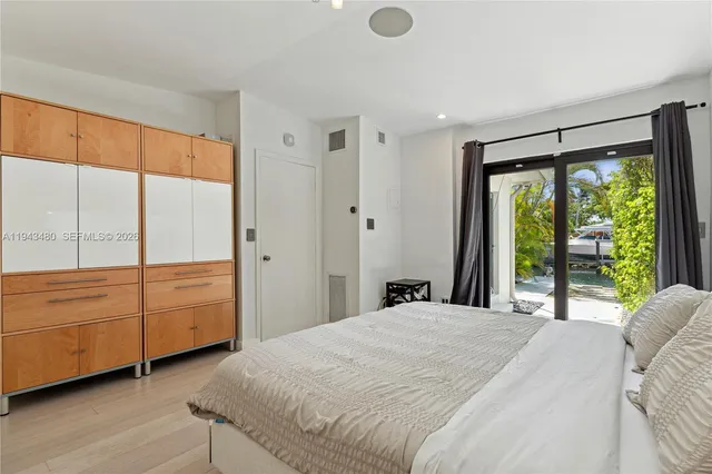 a bedroom with a bed and a view of kitchen
