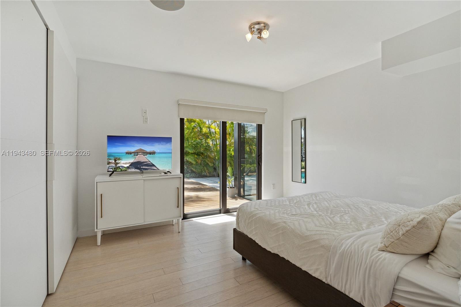 12901 Oleander Road North Miami, FL 33181 - Photo 22 of 30 a bedroom with a bed and a view of kitchen