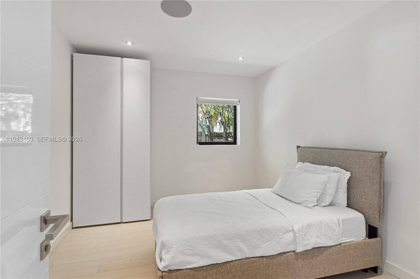 12901 Oleander Road North Miami, FL 33181 - Photo 23 of 30 a bedroom with a bed and a window