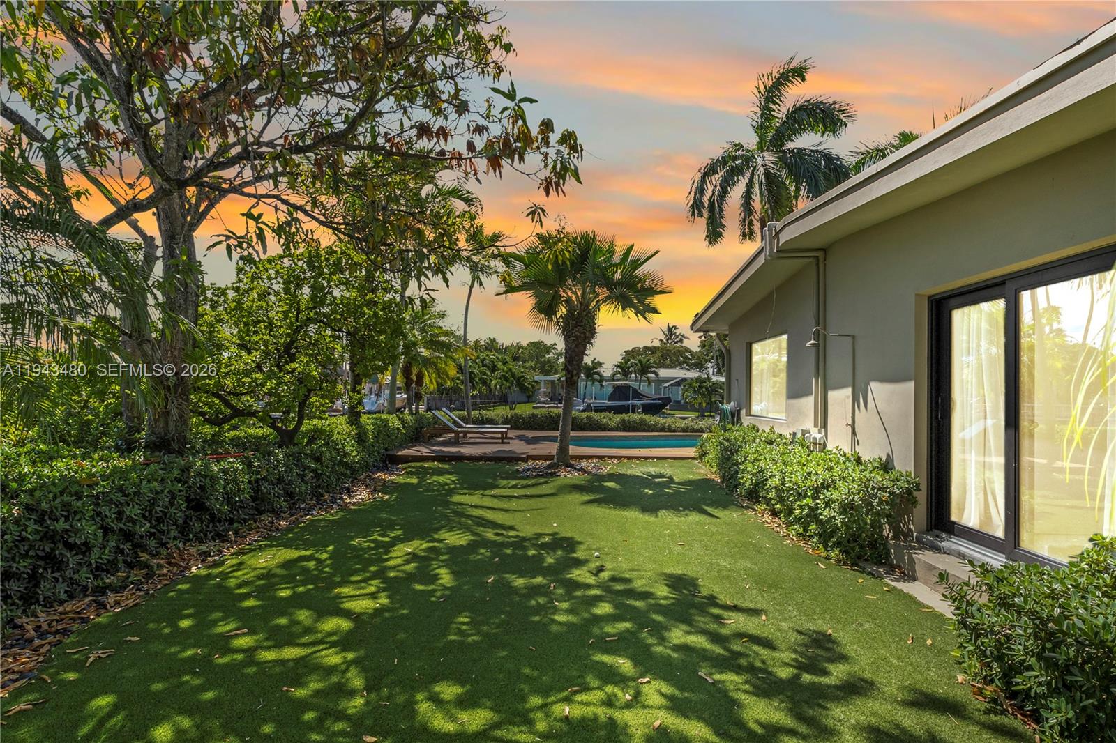 12901 Oleander Road North Miami, FL 33181 - Photo 27 of 30 a view of backyard with table and chairs and potted plants