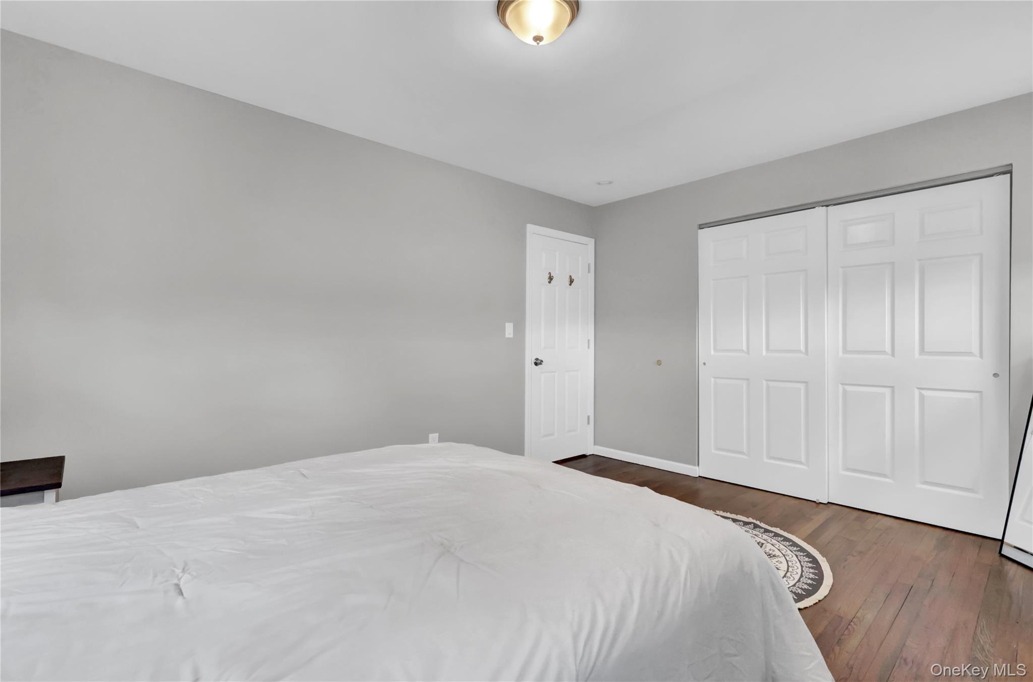 7 Winston Road Centereach, NY 11720 - Photo 14 of 18 a bedroom with a bed and a wooden floor