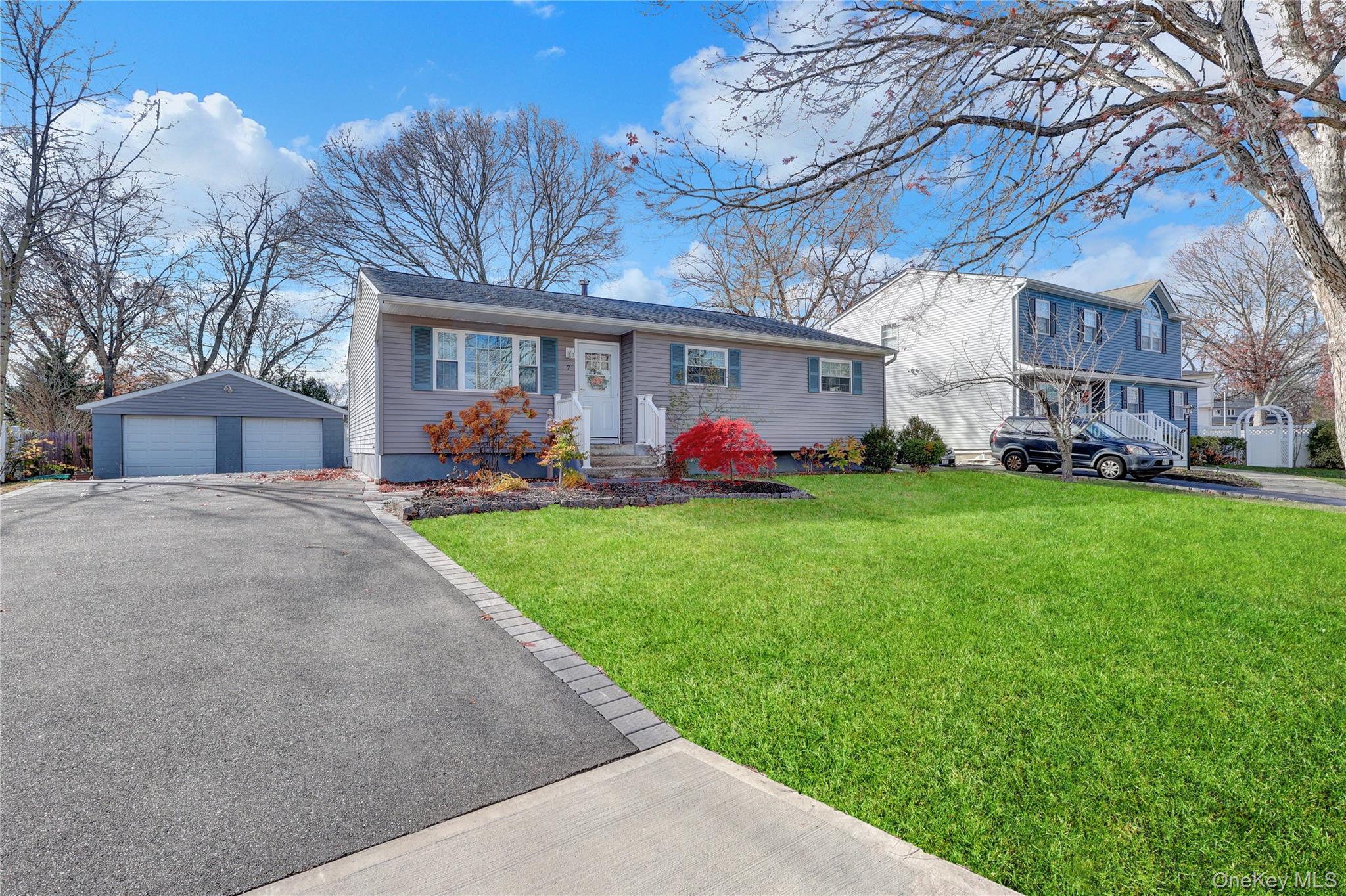 7 Winston Road Centereach, NY 11720 - Photo 2 of 18 a front view of house with yard and green space