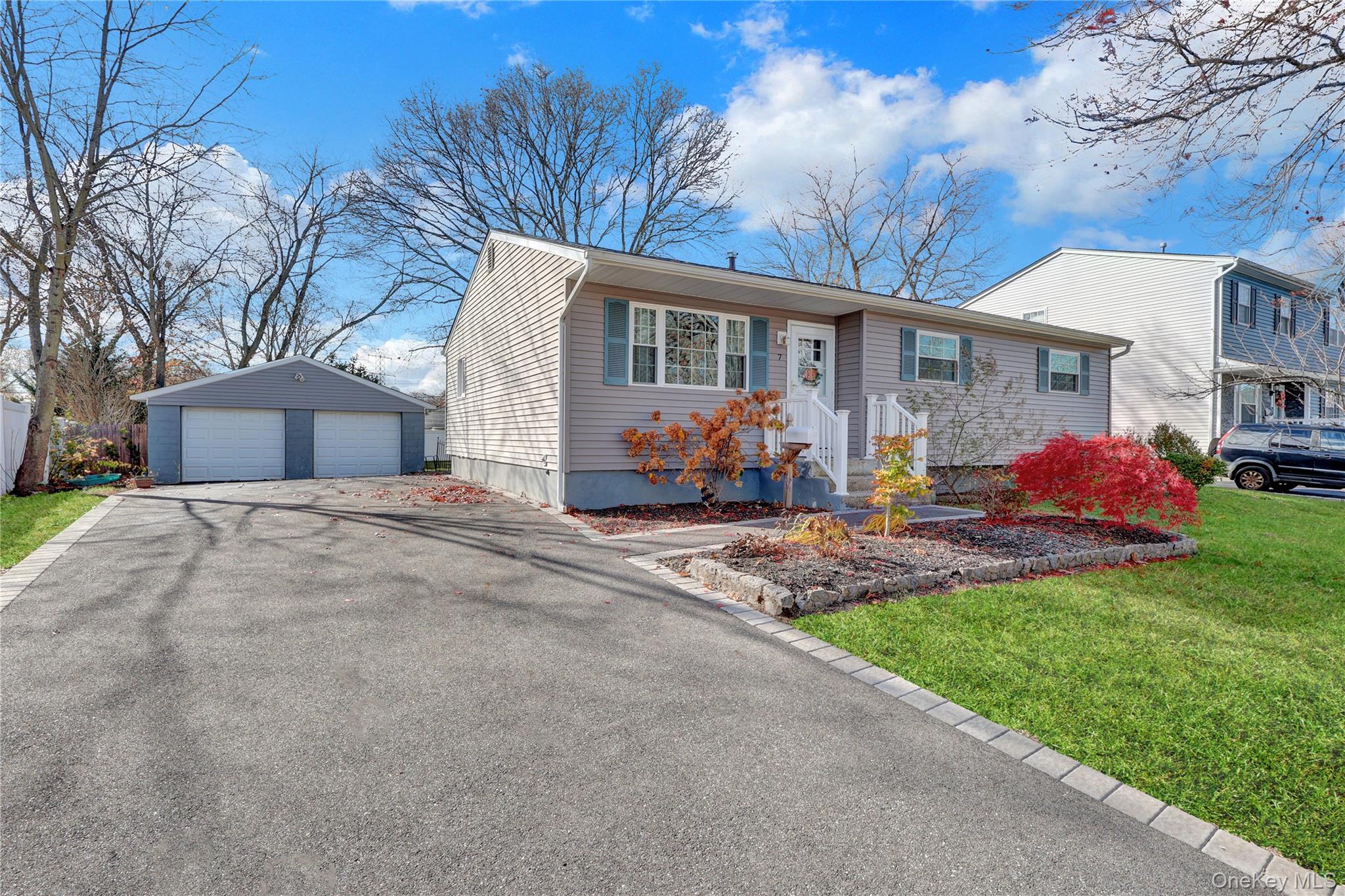 7 Winston Road Centereach, NY 11720 - Photo 4 of 18 a front view of a house with garden