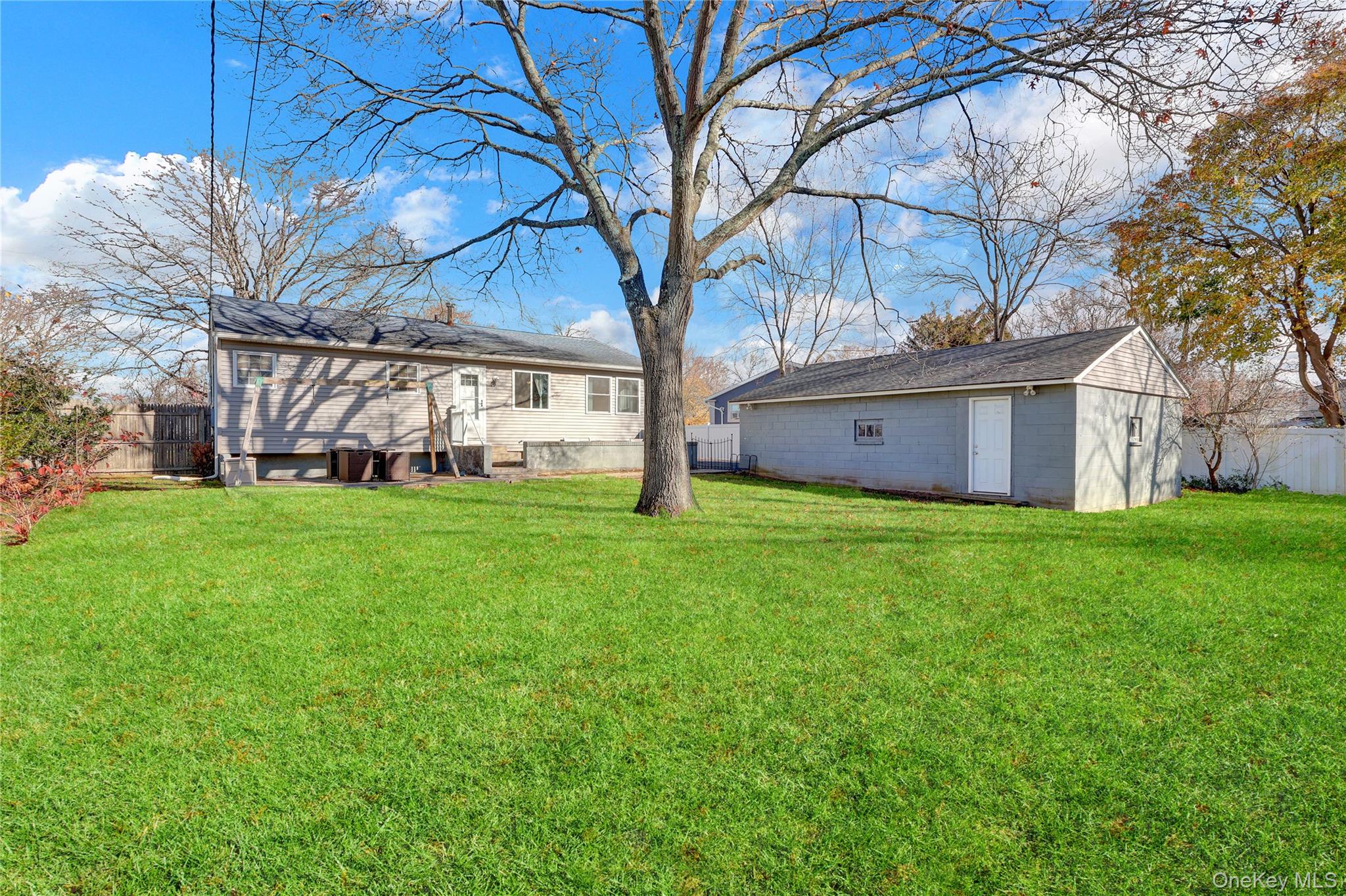 7 Winston Road Centereach, NY 11720 - Photo 5 of 18 a view of a house with yard and tree s