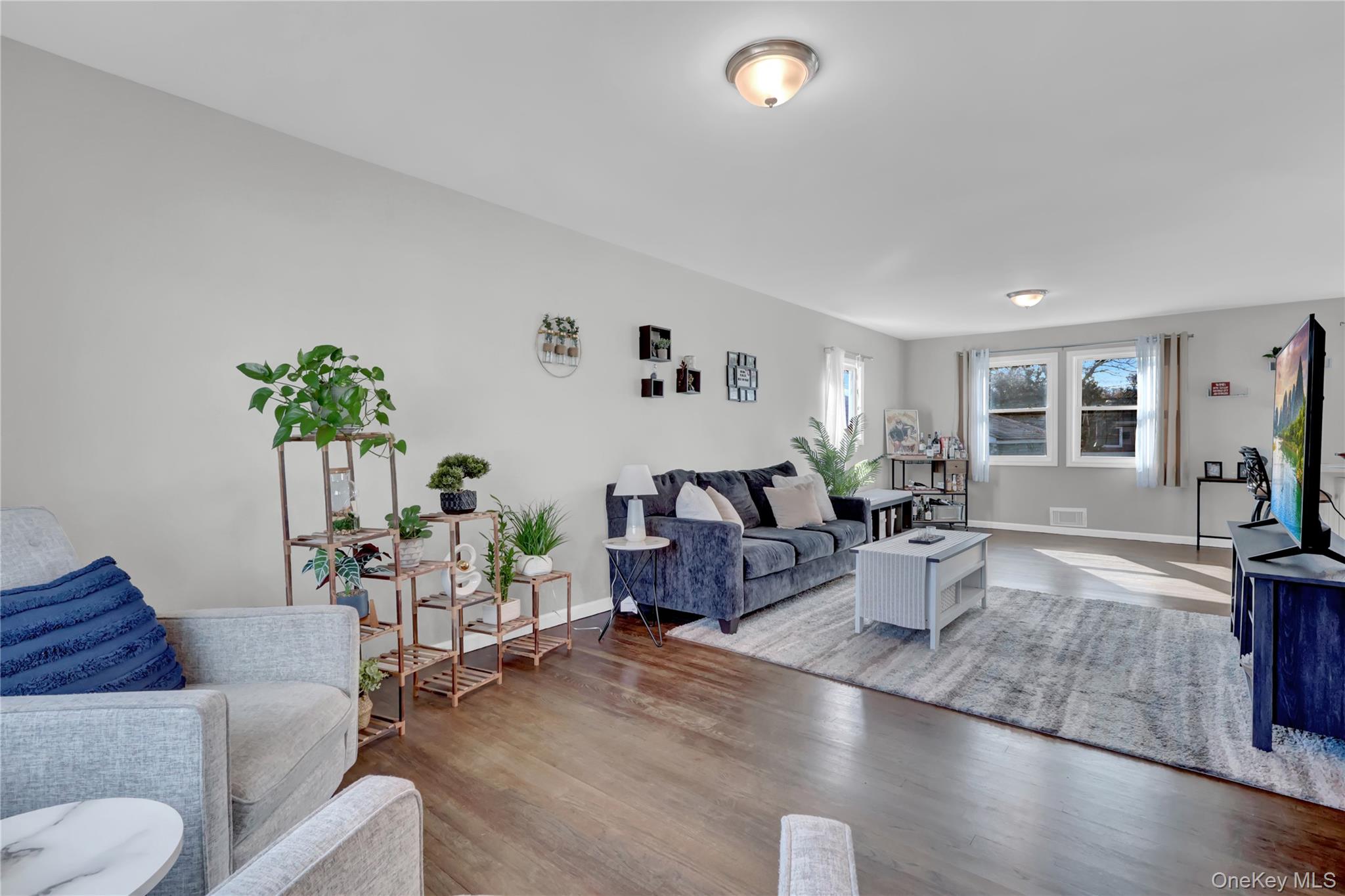 7 Winston Road Centereach, NY 11720 - Photo 8 of 18 a living room with furniture and a potted plant