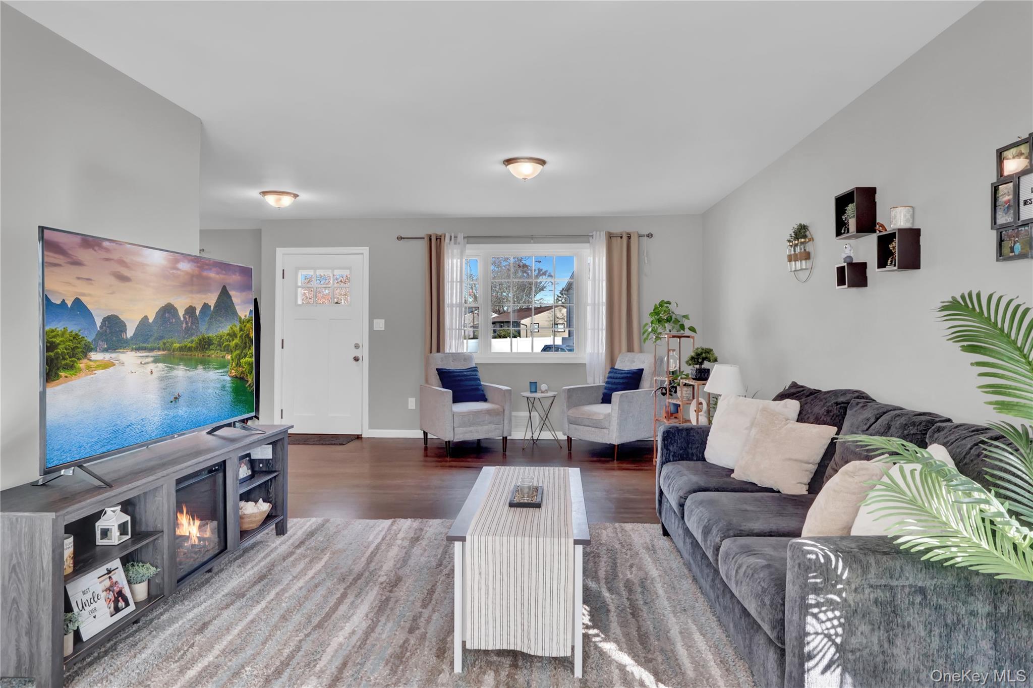 7 Winston Road Centereach, NY 11720 - Photo 9 of 18 a living room with furniture and a flat screen tv