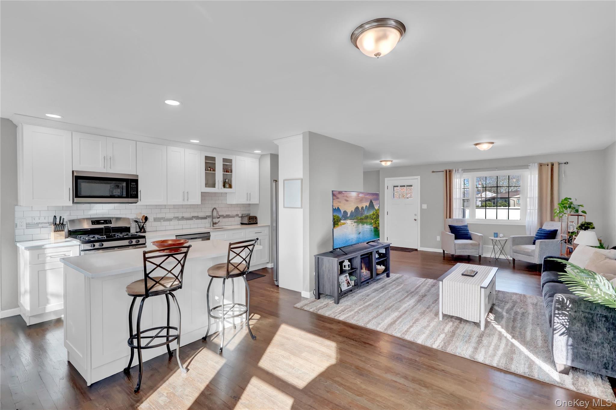 7 Winston Road Centereach, NY 11720 - Photo 10 of 18 a living room with furniture a dining table and kitchen view