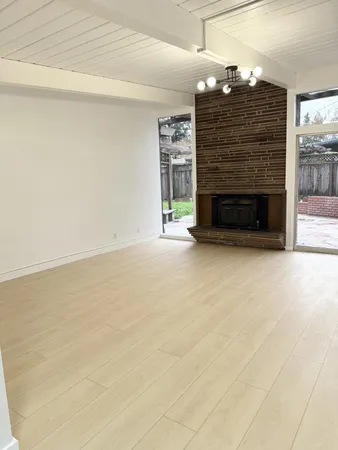 a view of an empty room with a fireplace