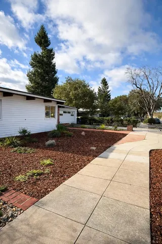 a swimming pool with yard view and sitting space