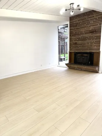 a view of an empty room with a fireplace
