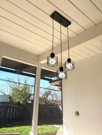a view of a room with a floor to ceiling window and wooden fence